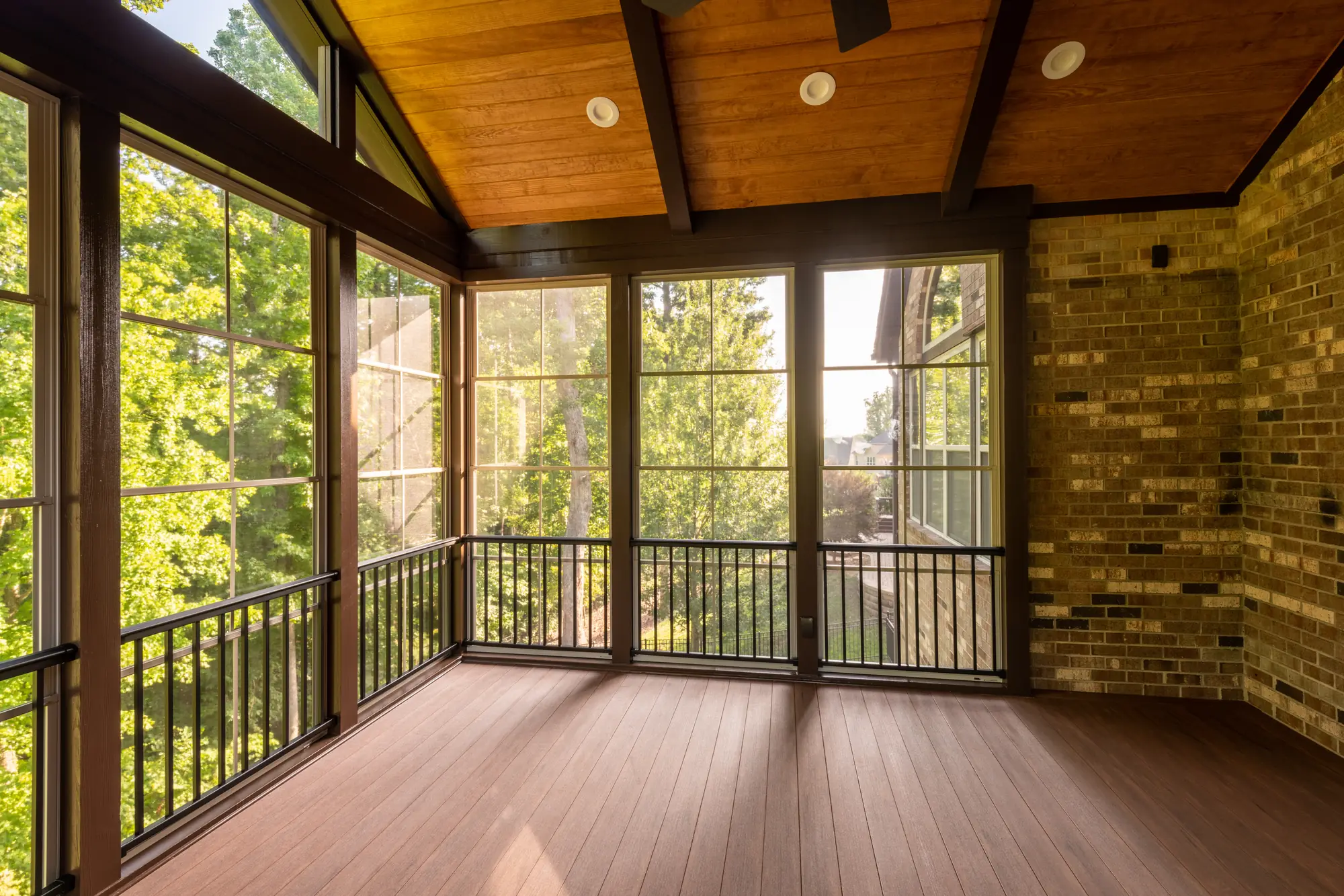 Finished screened porch with a stained wood ceiling