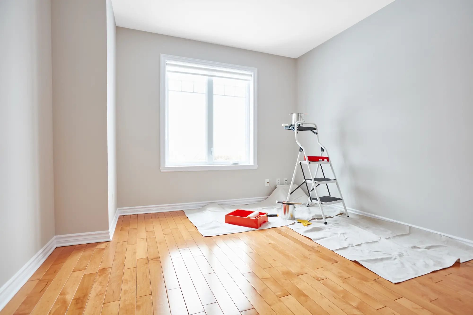 Freshly painted room with a ladder and roller tray