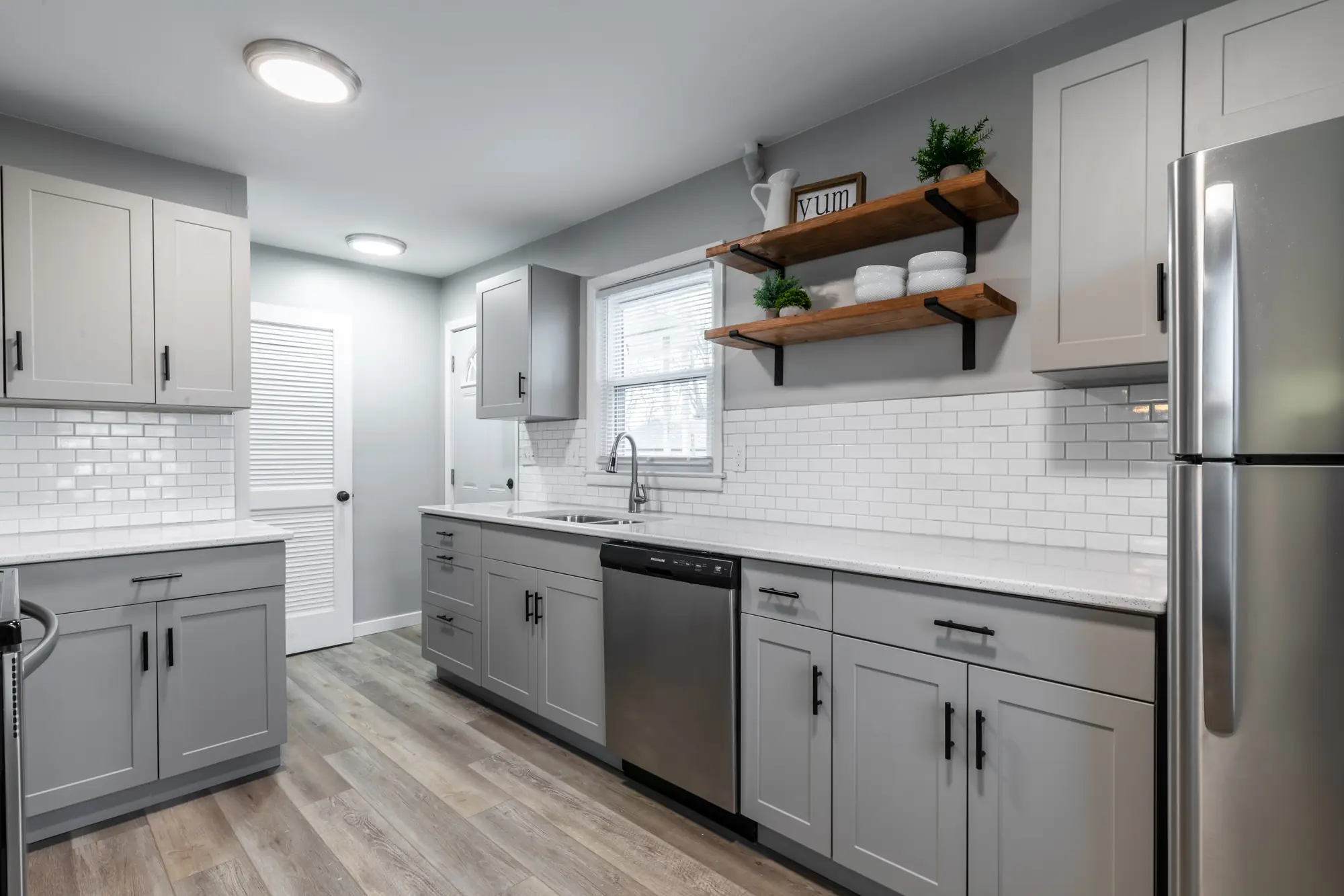 Finished kitchen with shaker cabinets and a subway tile backsplash
