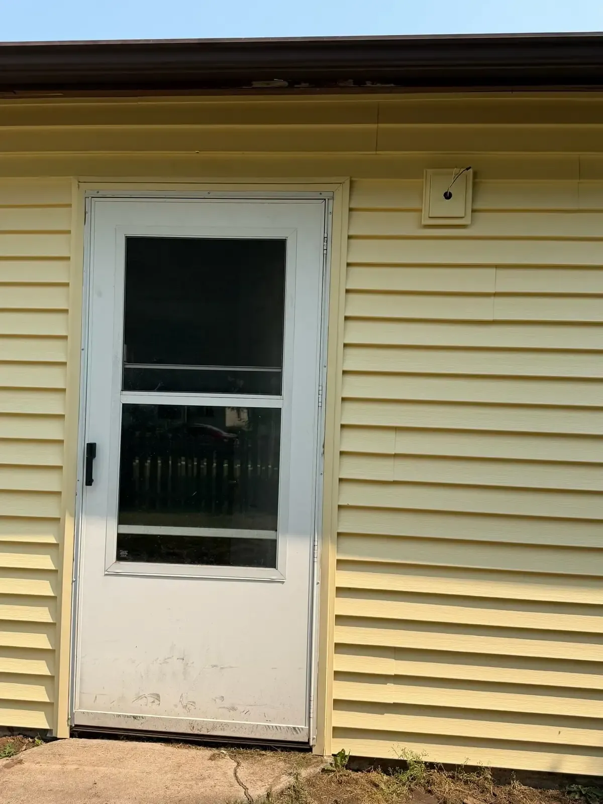 Trimmed door surround in new lap siding, with the courses returned into the opening