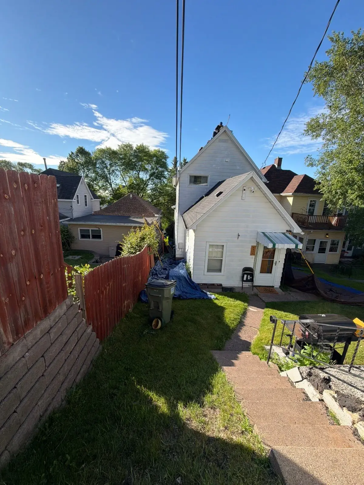 Roofers installing shingles on a Cloquet home