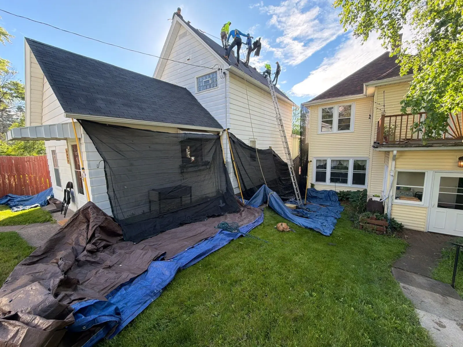 Covenant Builders crew replacing a roof in Hermantown