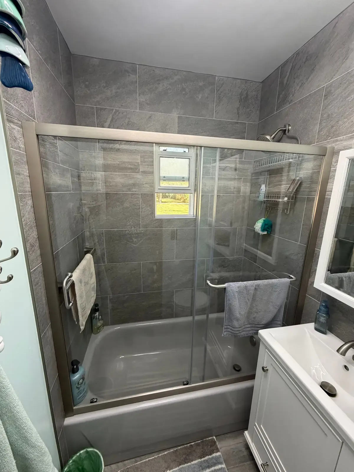 Tiled tub and shower surround with framed sliding glass doors